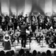 Der Kammerchor der TU Dortmund Der Kammerchor der TU Dortmund bei einem Konzert im Konzerthaus Dortmund.